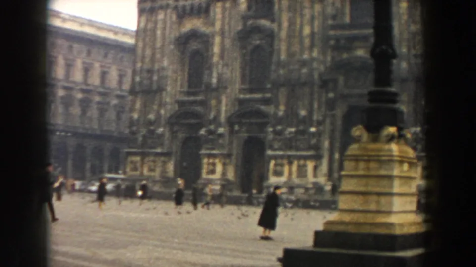 A wider 1959 8mm view shows Milan Cathedral opening onto the piazza, with pedestrians, pigeons, and surrounding buildings visible.
