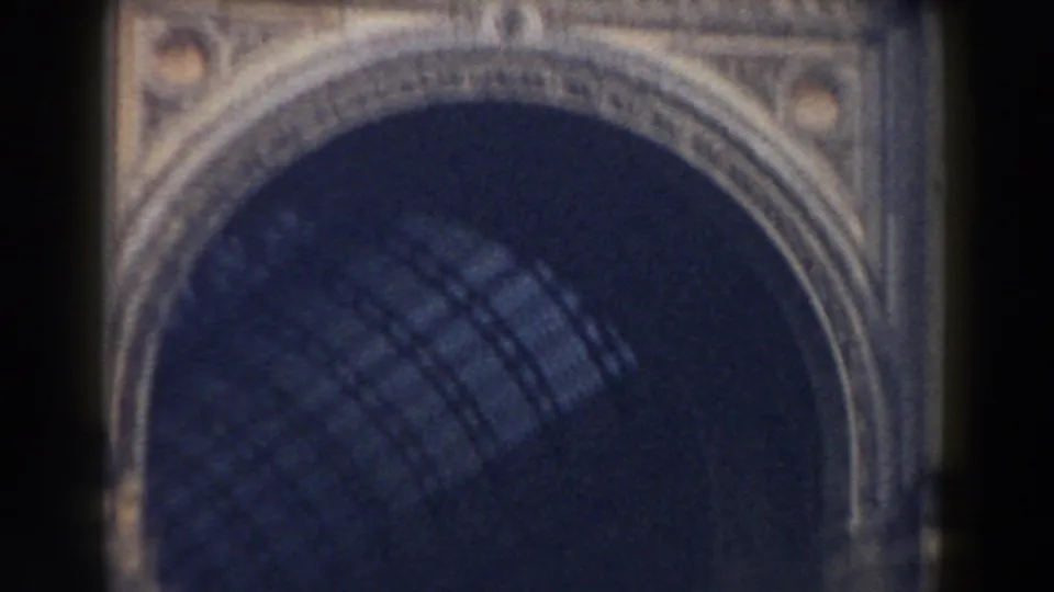 1959 Pisa frame showing a close, soft-focus view of a large arched architectural opening with patterned shadow inside and ornate stone detail around it.