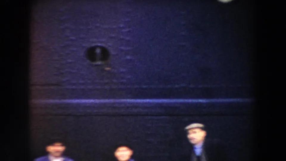 Pisa, Italy 1959 home-movie frame showing blurred passengers gathered below the aircraft at night.