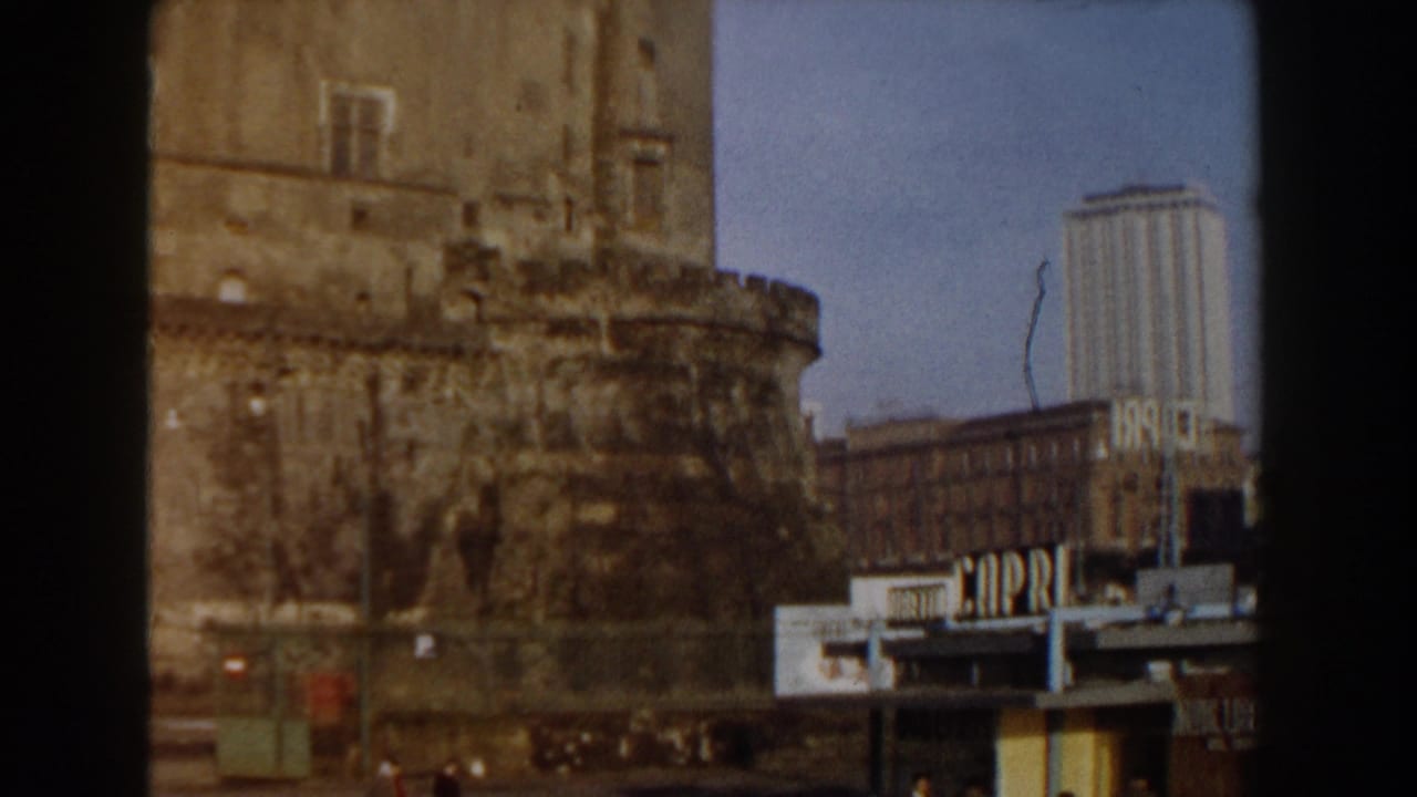 Fortress wall with a tall modern building and CAPRI sign nearby.