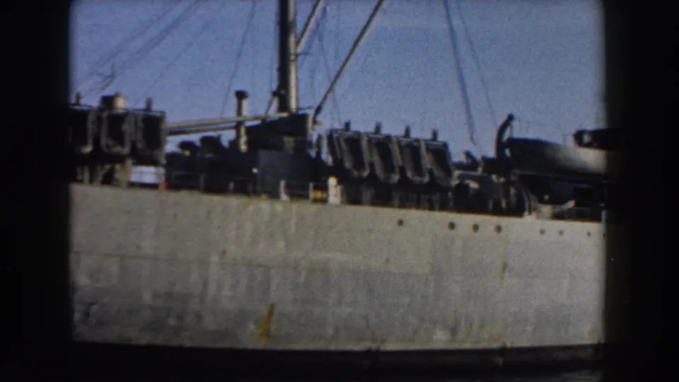 A soft 8mm frame from Pisa, Italy, showing the military vessel's side, rigging and clustered deck hardware.