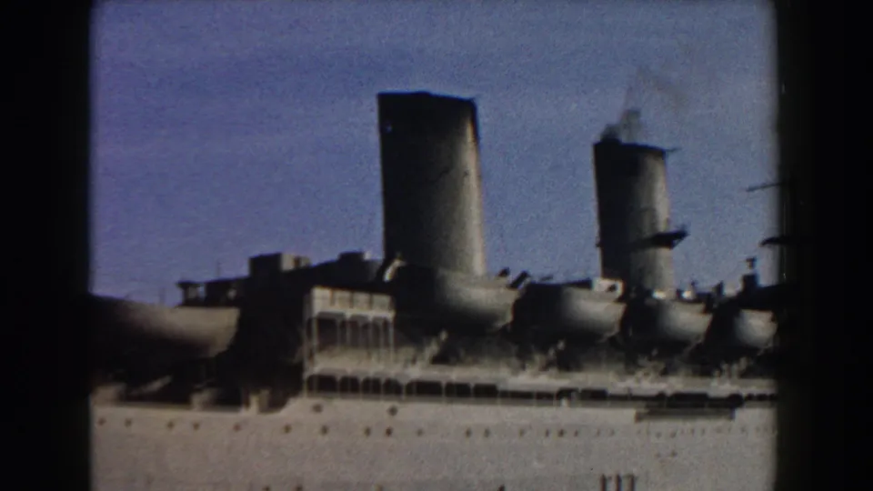 1959 Italy 8mm frame with a closer view of the ship's funnels, upper deck windows, portholes, and pale hull.