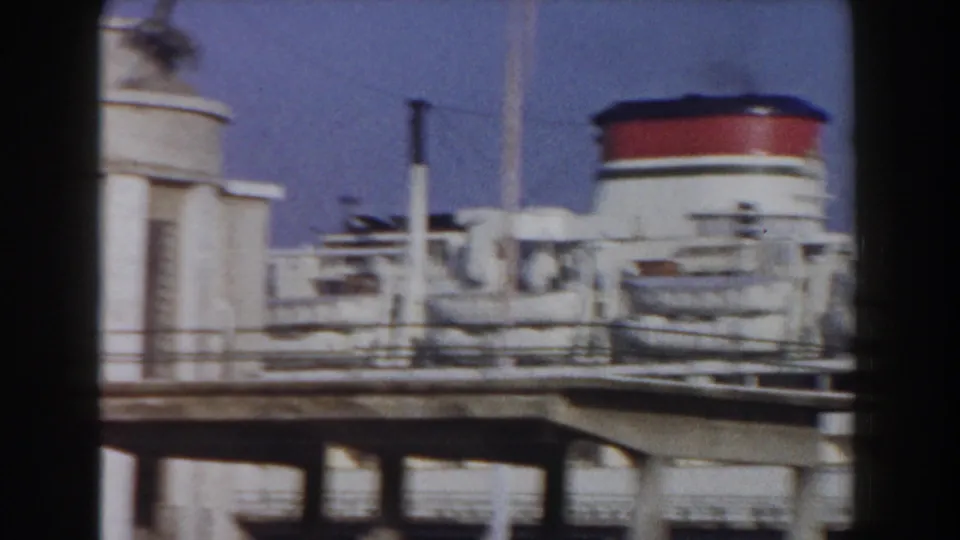 1959 Pisa, Italy dockside view of a passenger ship area with red-and-white funnel, railings, pipes, and deck equipment.