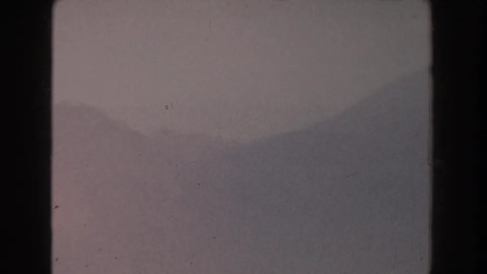 1959 Pisa, Italy 8mm still with layered mountain silhouettes receding through foggy haze.