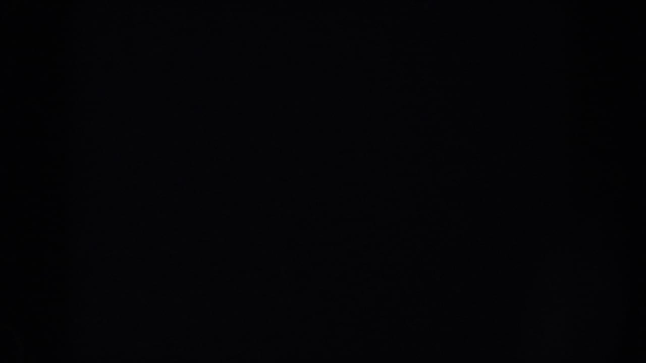 Nearly black 8mm frame with faint grain and no visible objects.