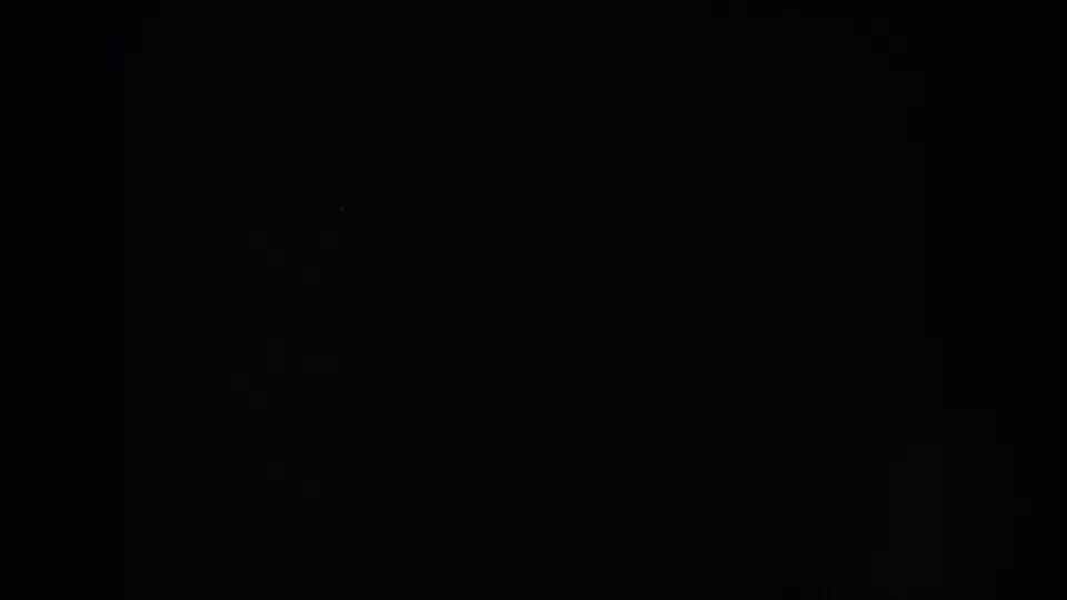Dark blank 8mm home-movie frame from supplied 1953 South Dakota metadata, with only grain and tiny specks visible.