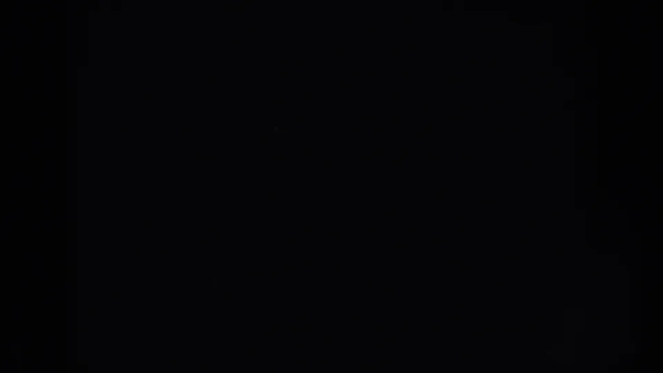 Almost entirely black 8mm frame, supported as 1953 South Dakota footage, with faint texture and no identifiable content.
