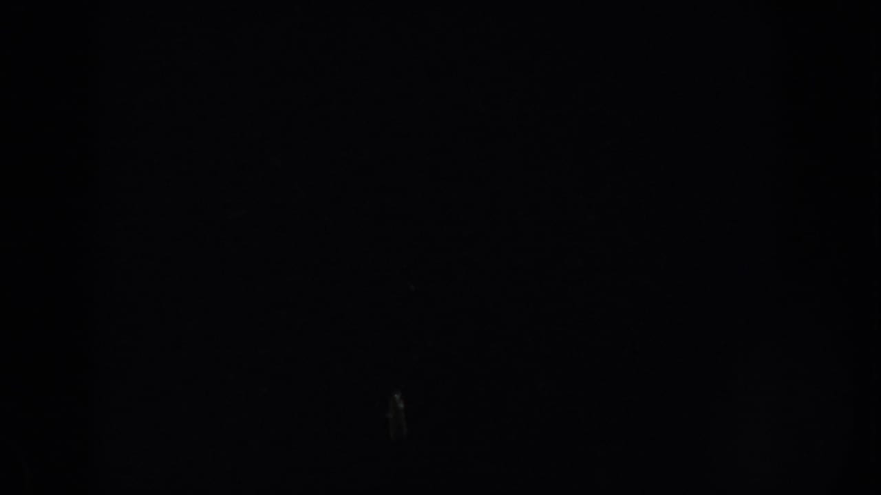 Mostly underexposed 8mm frame from the South Dakota clip, with no clear subject visible.
