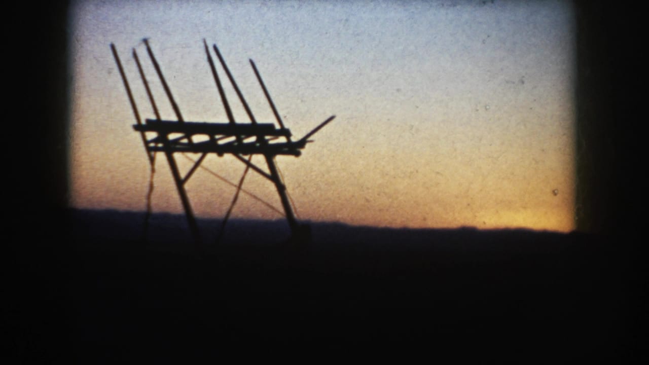 Final 1953 South Dakota frame with the antenna-like silhouette centered against pale gold evening sky and a dark horizon line.