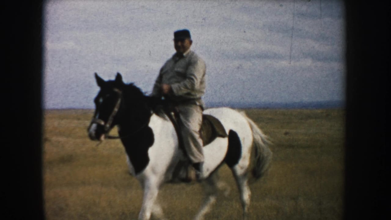 A closer 1953 South Dakota frame shows the rider seated on a pinto horse against open prairie and a pale cloudy sky.