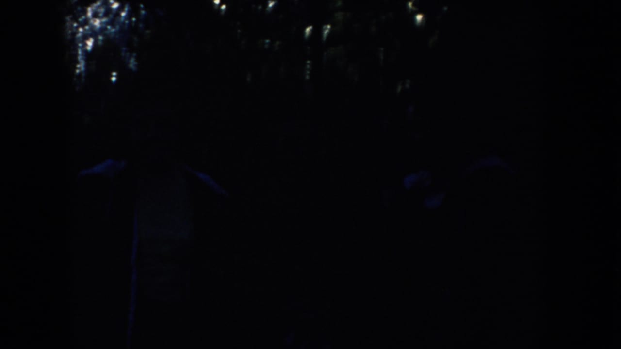 Dark blue 1953 South Dakota frame with scattered highlights and an indistinct silhouetted person shape at right.