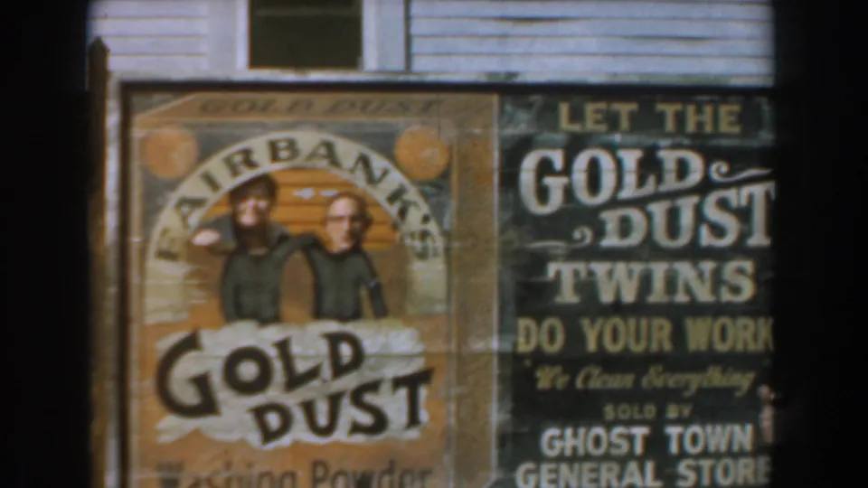 Close view of Knott's Berry Farm storefront signage showing Gold Dust Washing Powder artwork and a Ghost Town General Store sign.