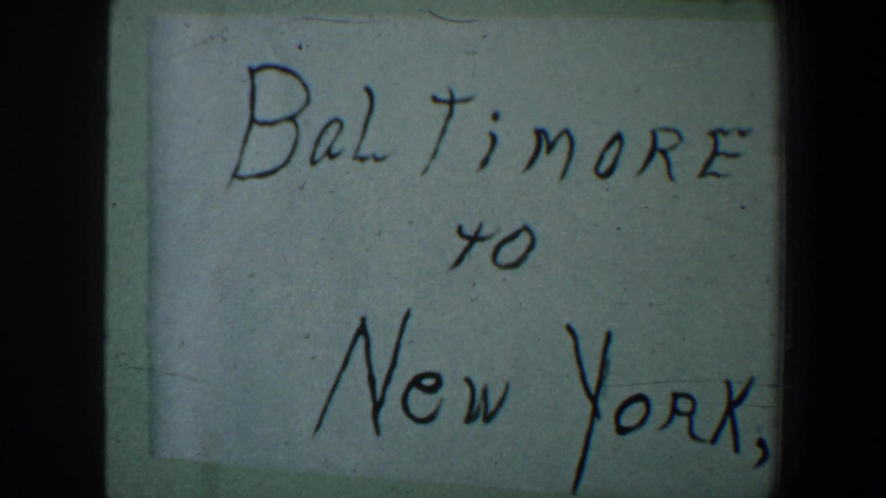 Close view of the same handwritten Baltimore to New York note framed by dark film edges.