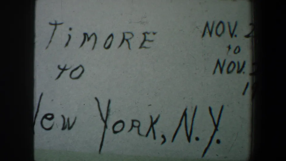 1960 8mm home-movie title card with partial Baltimore to New York, N.Y. wording and cropped November date text.