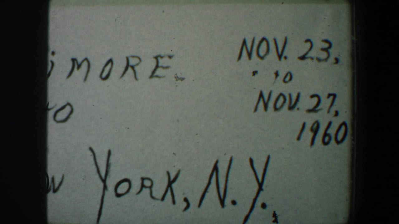 1960 8mm frame of a handwritten Baltimore-to-New York title card, partially cropped with Nov. dates visible.