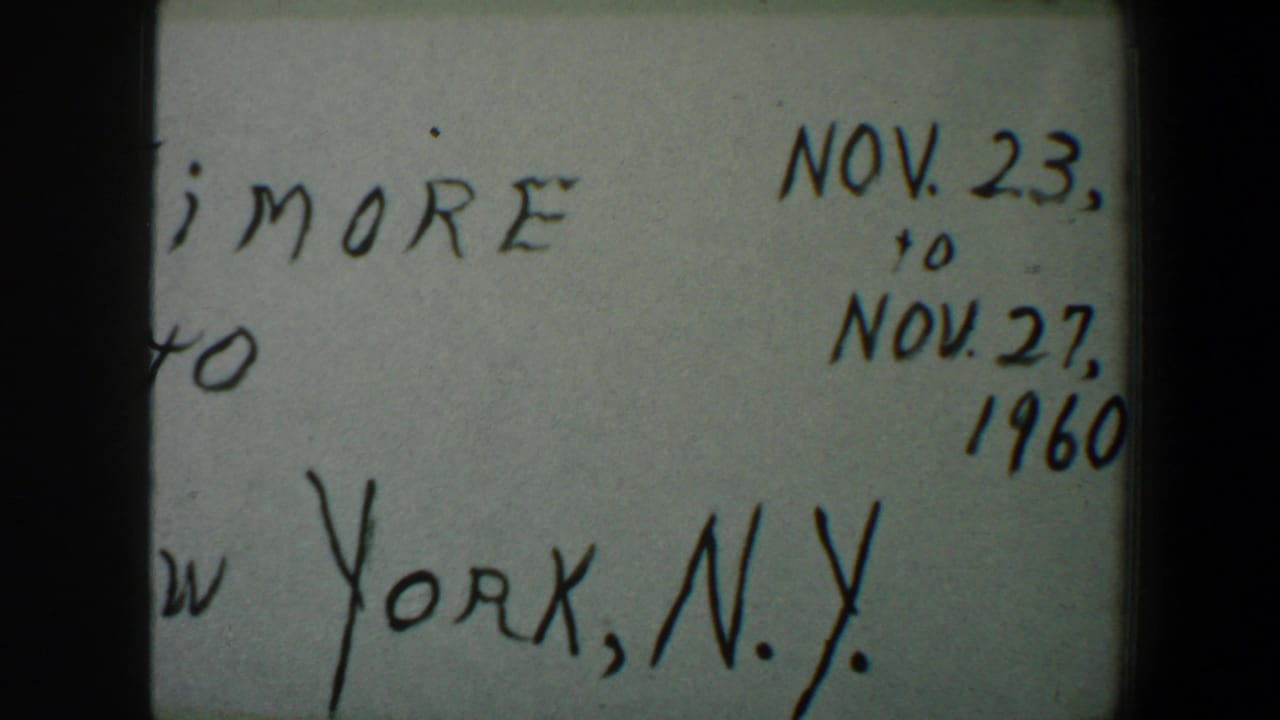 1960 8mm frame of the handwritten travel note, showing partial New York, N.Y. text and November date markings on the right side.