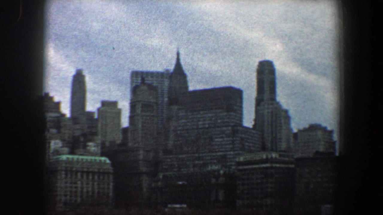 1960 New York City skyline seen from across the water, with dense high-rises in soft 8mm color.