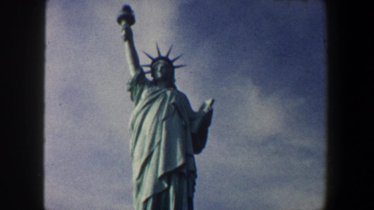 Low-angle view of the Statue of Liberty against a partly cloudy sky.