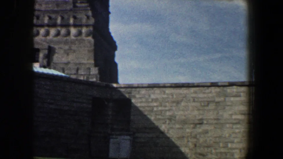 1960 New York City 8mm frame showing the lower pedestal area and stone wall beneath the Statue of Liberty.