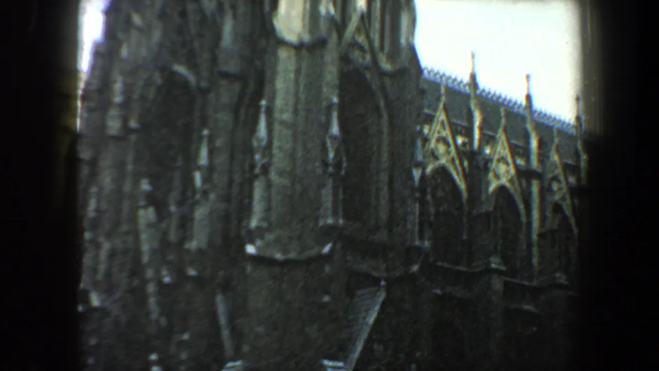 Soft 1960 New York City 8mm view of the Gothic-style church side wall, arched windows, and stone roof details.