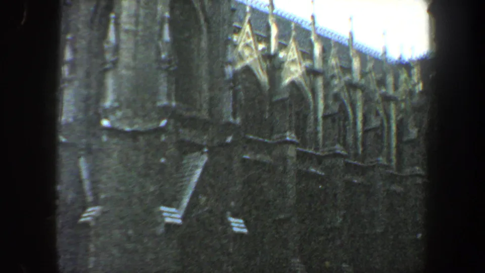 Dark foreground framing encloses a soft 8mm view of ornate New York City architectural details.