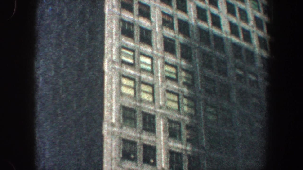 Skyscraper window grid and facade details seen from below.