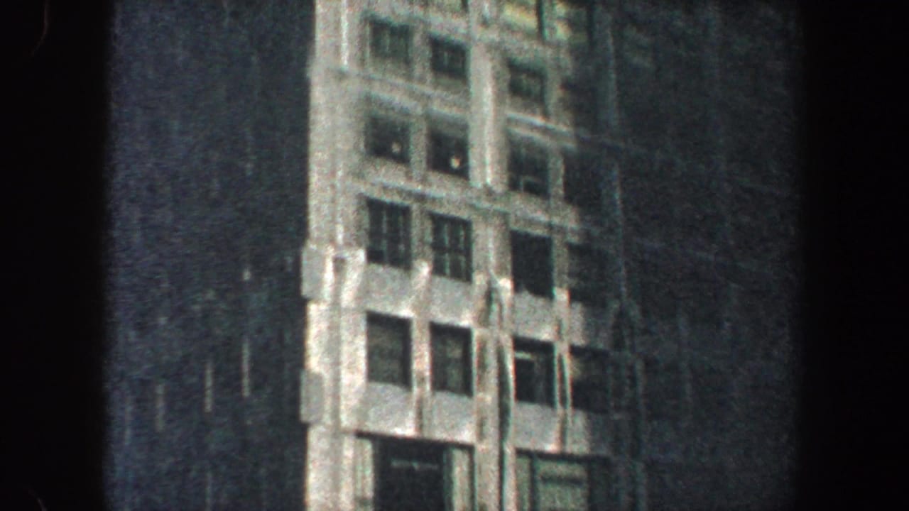 Close view of an office building facade with vertical details and windows.