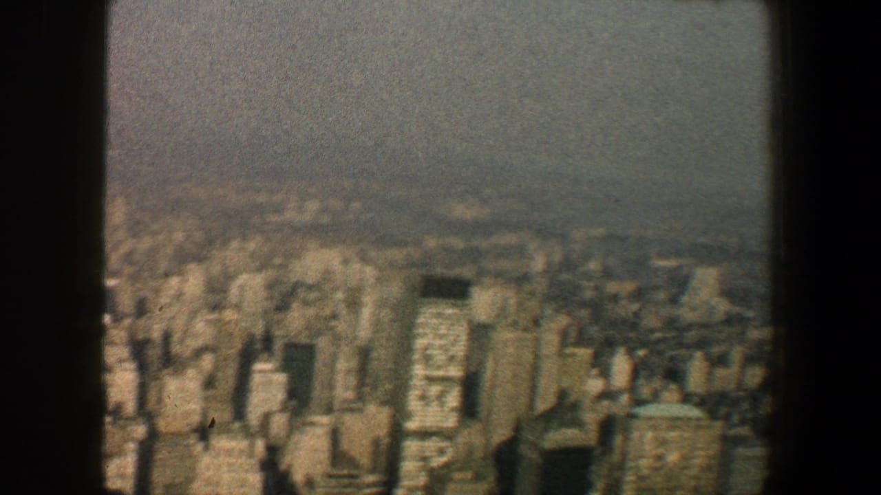 Manhattan skyline viewed through a dark central structural beam.