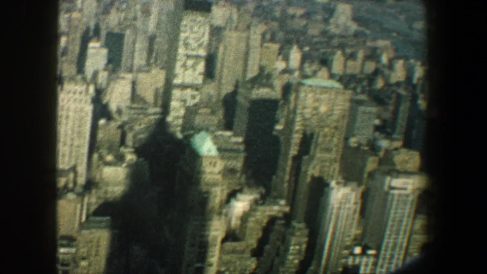 Manhattan high-rises below the Empire State Building viewpoint, recorded on soft color 8mm film in 1960.