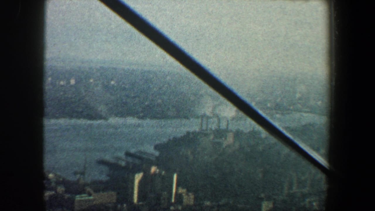 Elevated city and water view partly crossed by a dark diagonal beam.