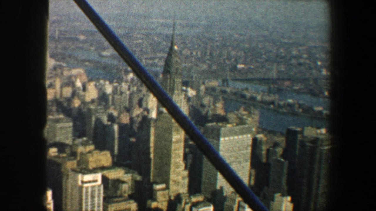 Chrysler Building and Manhattan high-rises viewed through dark window-like framing.