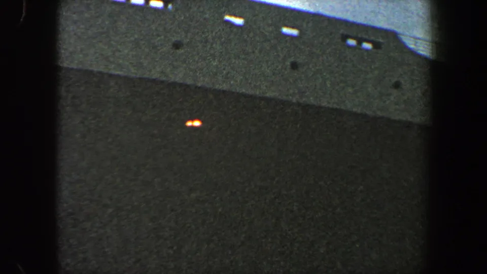 1960 New York City home-movie frame showing the side of a large vessel below the observation vantage point.