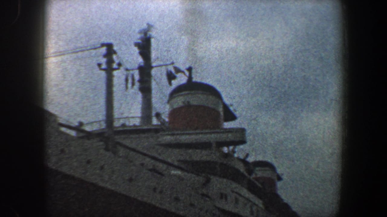 Ocean liner upper deck and red-and-white funnel framed beside dark film gate edges.