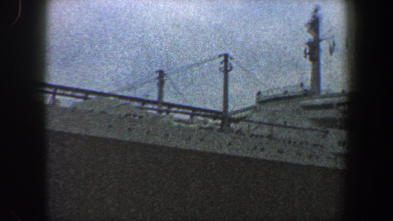 Large ocean liner upper decks and mast seen through dark 8mm frame edges.