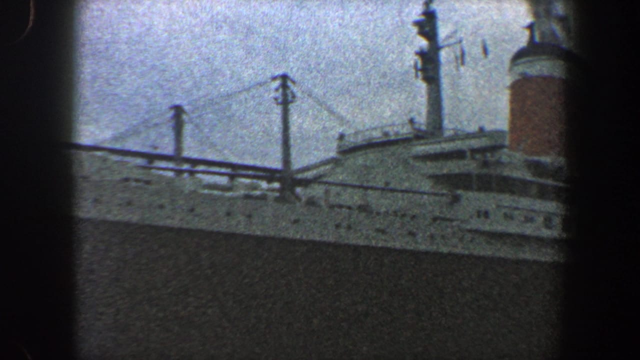 Ocean liner upper decks with funnel, mast details, and dark hull below.