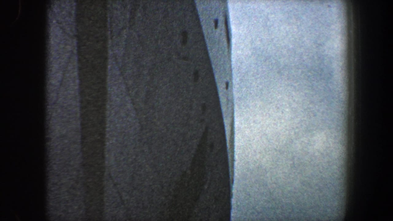 Ship hull and bright sky divided by a dark vertical frame edge.