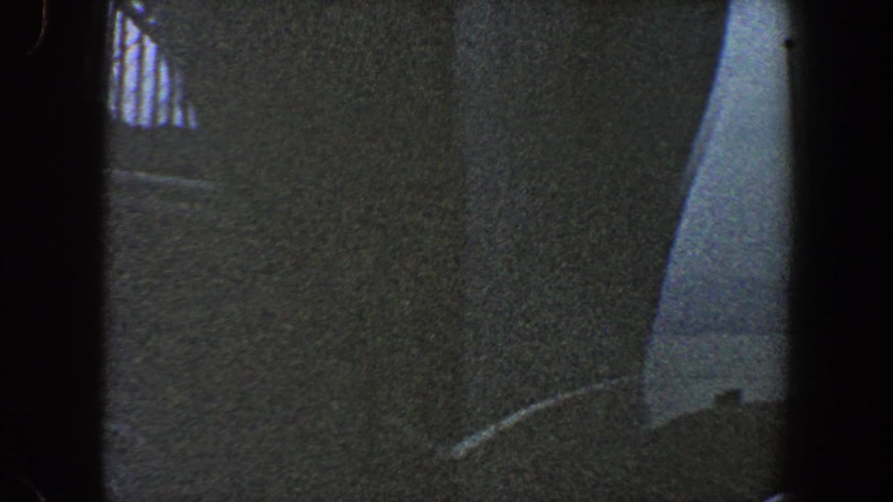 1960 New York City 8mm frame showing a low-angle bridge construction view with dark supports and steel framework overhead.