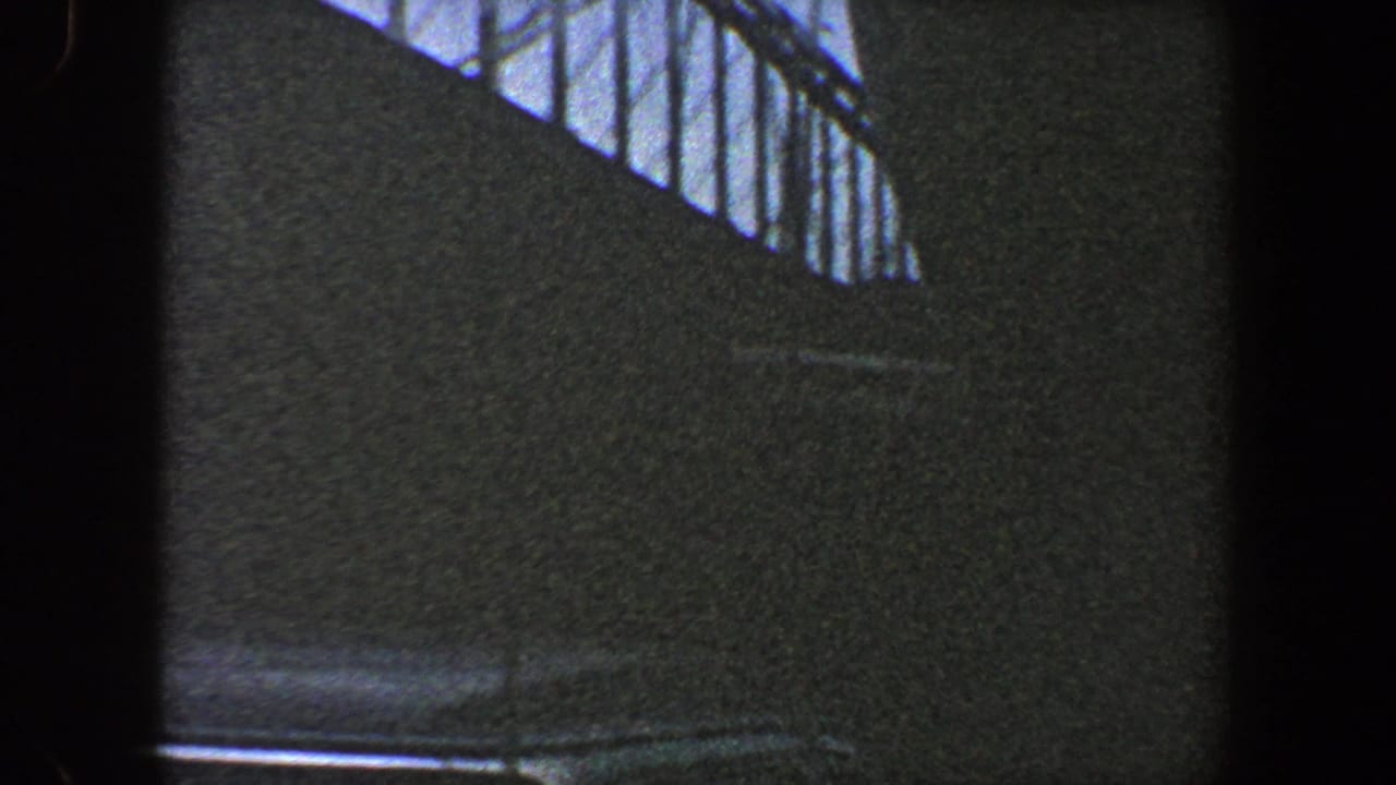 Dark bridge wall with a band of steel framework along the top edge.