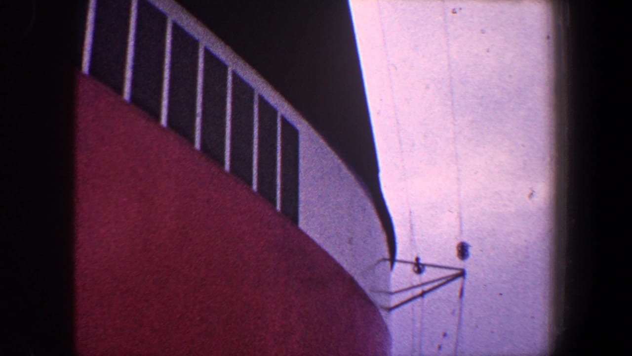 Low-angle view of red and white painted structure with vertical railings.