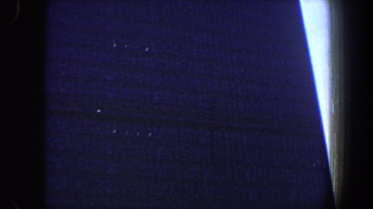 Dark blue frame with a bright vertical streak and faint surface specks.