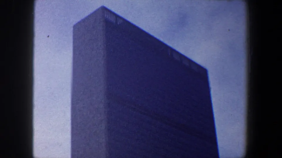 1960 New York City frame of the United Nations Headquarters building, tightly composed with sky and 8mm border artifacts.