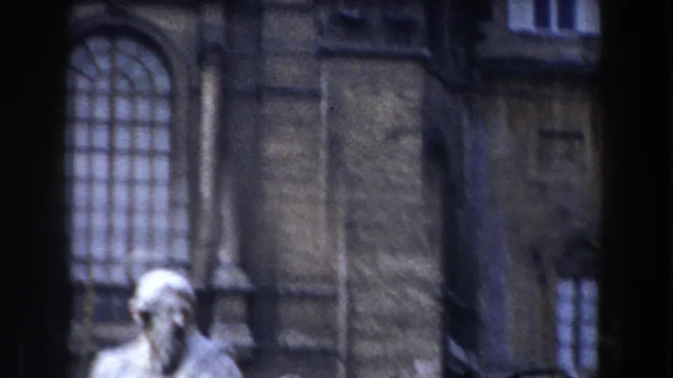 1959 Rome frame showing a soft-focused stone figure against a dark building facade with an arched window.