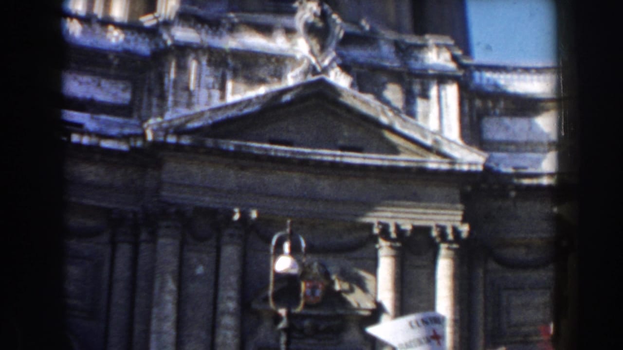 Stone building facade with columns, pediment, street lamp, and dark 8mm frame edges.