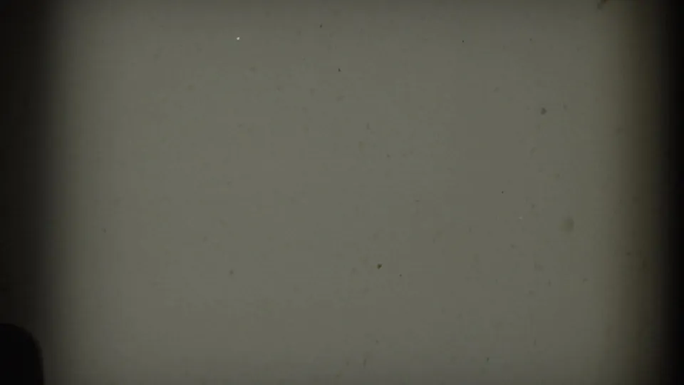 Blank or overexposed 8mm frame section from the 1959 Rome clip, showing muted film color, dust specks, and vignetted edges.