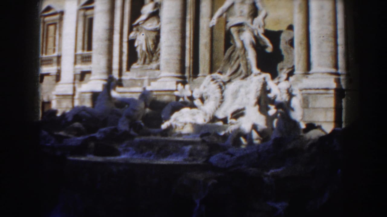 Trevi Fountain sculptures and columns partly covered by deep shadow.