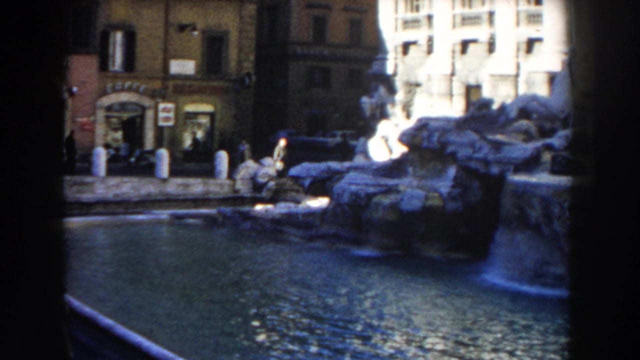 Trevi Fountain water and stonework seen across a dark film gate divider.