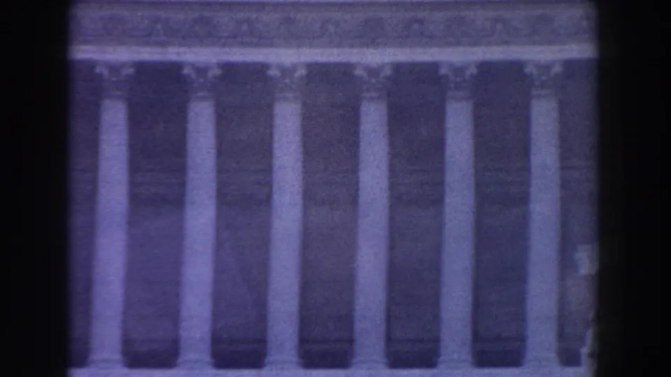 1959 Rome home-movie view of a broad classical facade lined with tall columns under a horizontal stone cornice.