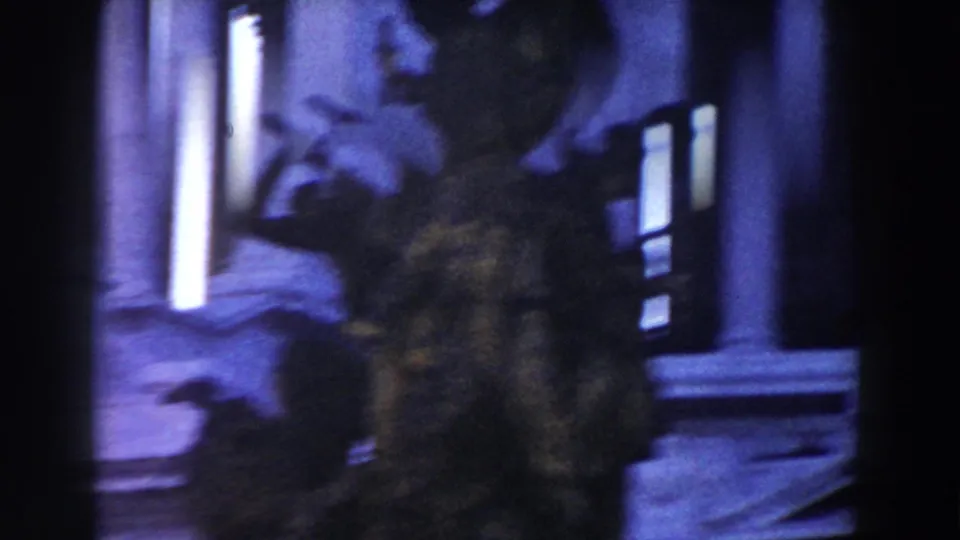 1959 Rome 8mm frame with a blurred sculptural form against a blue-tinted facade, tall windows and pale vertical highlights.
