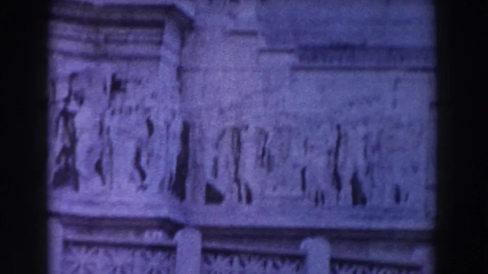 1959 Rome architectural detail with a relief panel and column tops, partially divided by the film frame edge.