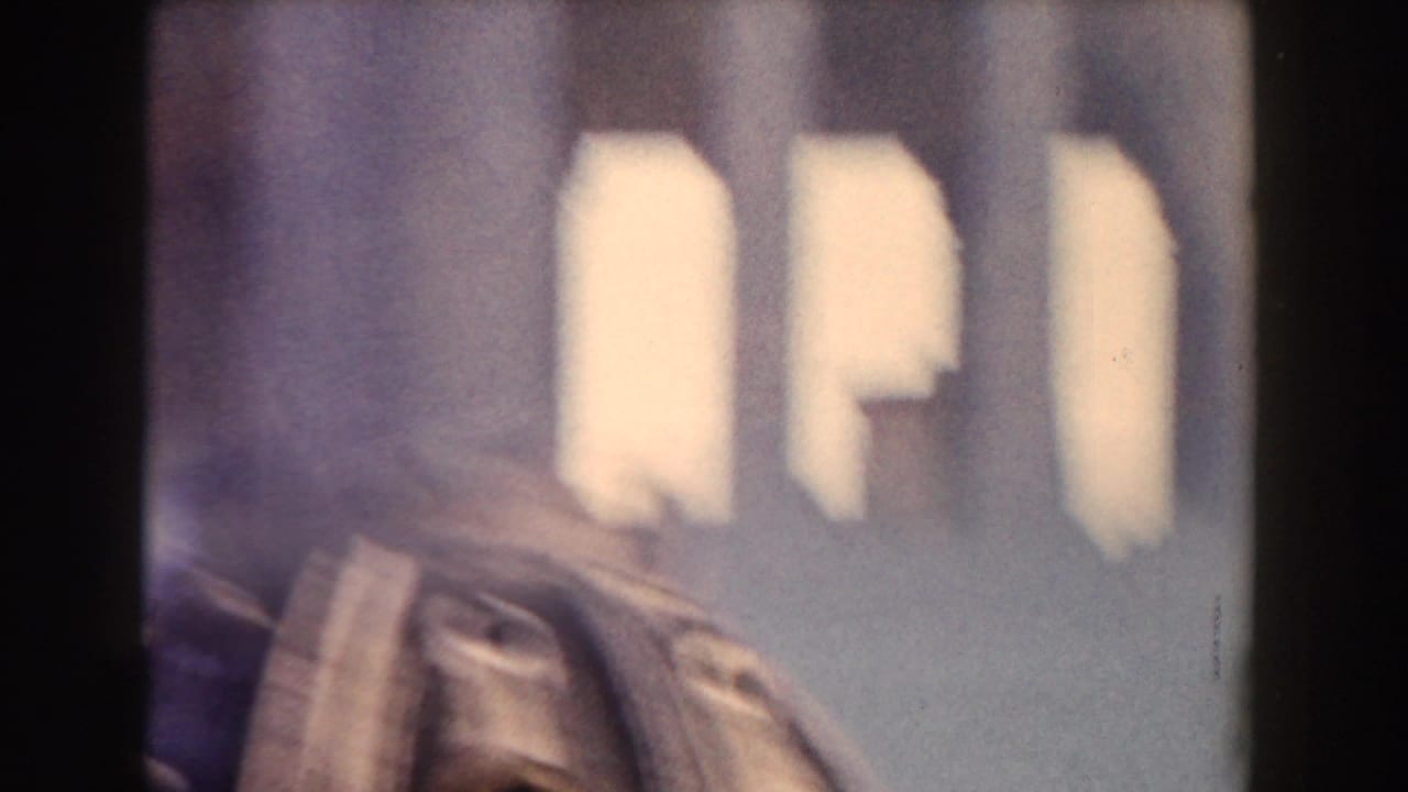 Soft, partial view of a domed architectural structure seen through film gate edges.
